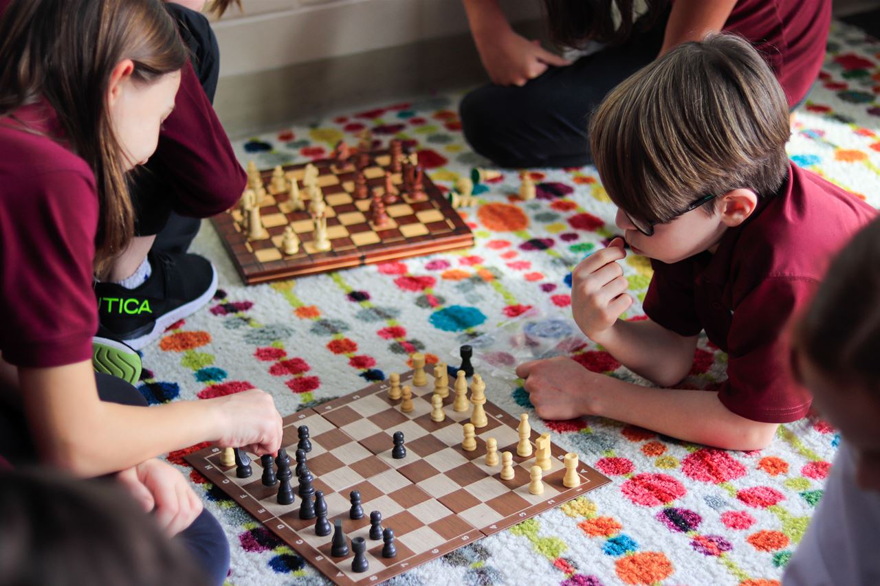Two Children Playing Chess at ISM School